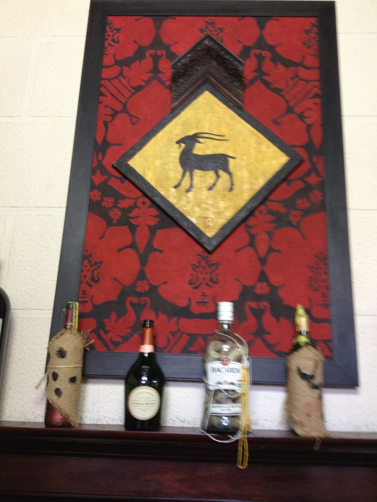 A large bottle of Bacardi Rum on the mantelpiece at our lunch in an elaborate dining room. ...